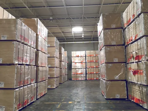 Wrapped pallets stacked high in a warehouse