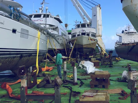 Motor yachts in cradles on a ship's deck